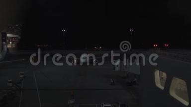 大飞机夜间停在机场附近，从候机楼窗口观看